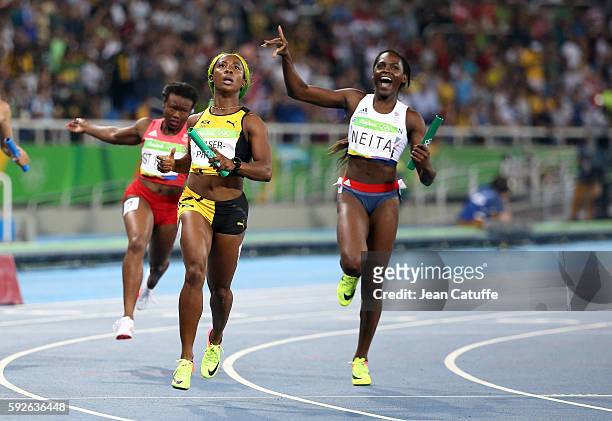 Shelly-Ann Fraser-Pryce of Jamaica and Daryll Neita of Great Britain following the Women's 4 x 100m Relay on day 14 of the Rio 2016 Olympic Games at...