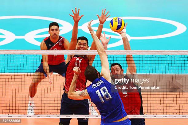 Micah Christenson of United States and David Lee of United States block the spike of Alexander Volkov of Russia during the Men's Bronze Medal Match...