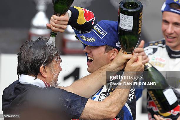 France's Sebastien Ogier celebrates with champagne and Volkswagen motorsport manager Jost Capito winning the WRC World Rally Championship ADAC Rally...