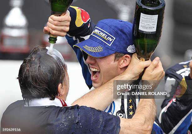 France's Sebastien Ogier celebrates with champagne and Volkswagen motorsport manager Jost Capito winning the WRC World Rally Championship ADAC Rally...