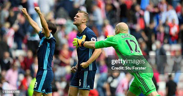 Middlesbrough players George Friend Ben Gibson and goalkeeper Brad Guzan celebrates on the final whistle during the Premier League match between...