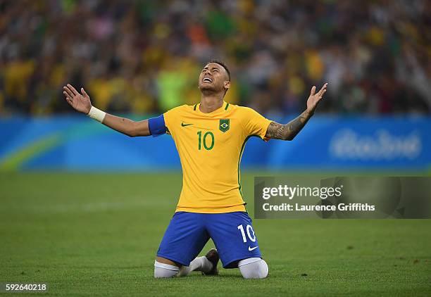 Neymar of Brazil celebrates scoring the winning penalty in the penalty shoot out during the Men's Football Final between Brazil and Germany at the...