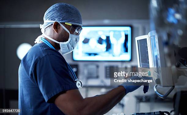 vigilantly monitoring his patient's vitals - equipment stock pictures, royalty-free photos & images