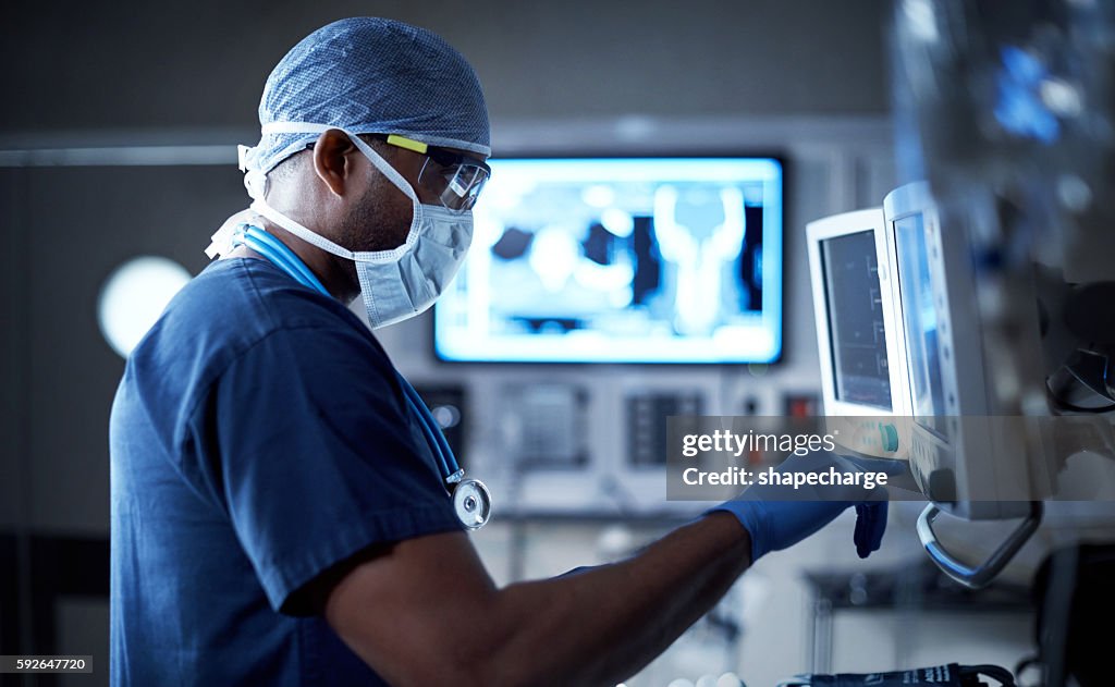 Vigilantly monitoring his patient's vitals