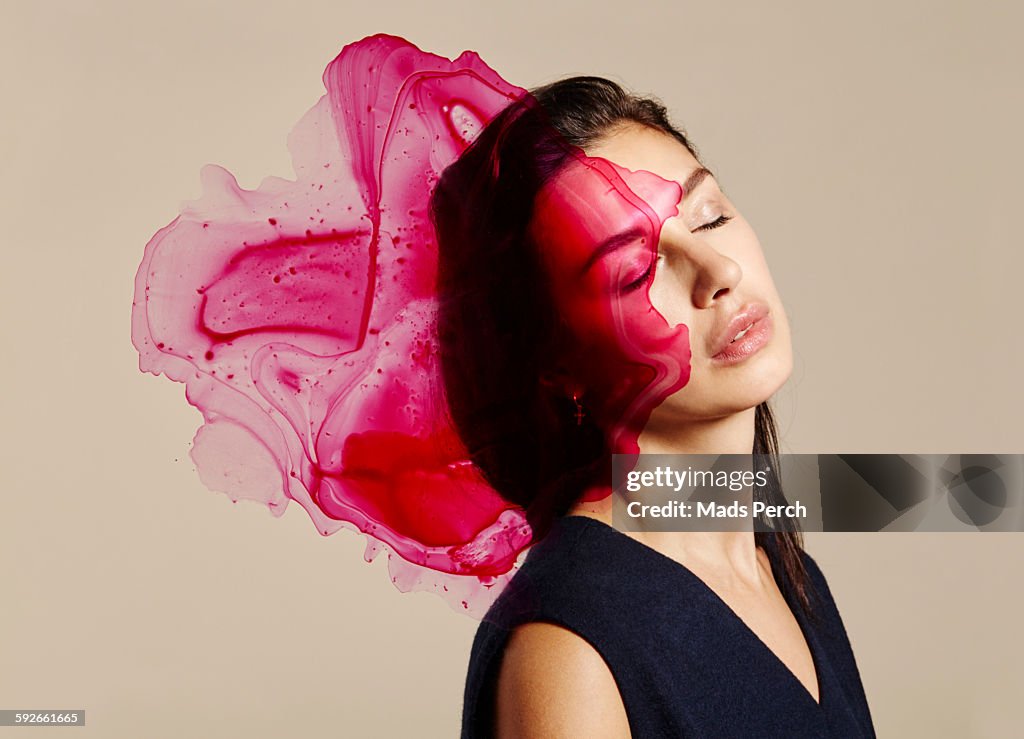 Woman with splatters of ink in front of her face