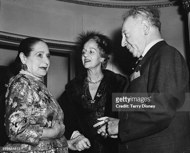 Beauty business magnate Helena Rubinstein meeting renowned pianist Arthur Rubinstein and his wife Aniela in London, November 26th 1957.