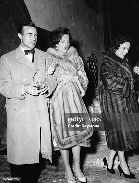 Diplomat and racing driver Porfirio Rubirosa and his wife Odile Rodin leaving the night club 'Chesa Veglia' in Saint Moritz in Switzerland, circa...