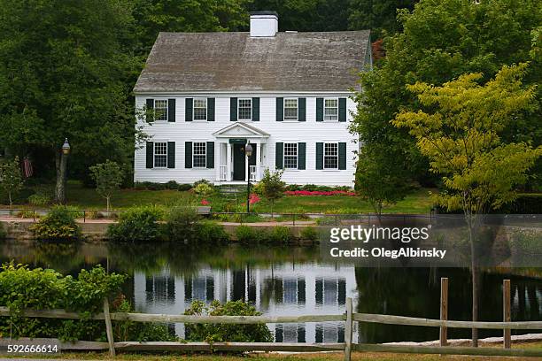 casa de lujo de nueva inglaterra en un estanque entre árboles, massachusetts. - colonial fotografías e imágenes de stock