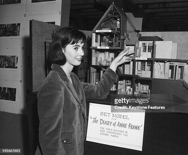 Actress Millie Perkins inspecting a set model of the house where Anne Frank and her family hid from the Nazi's, for the film 'The Diary of Anne...