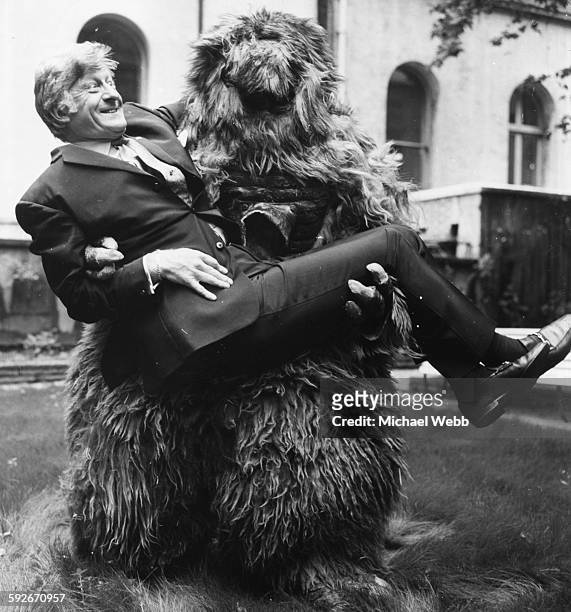 Portrait of 'Dr Who' actor Jon Pertwee being carried by one of the monsters from his television show, at BBC Television Centre in London, June 20th...