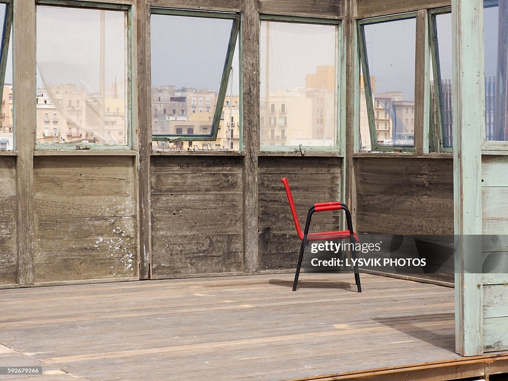 Red chair in wooden building