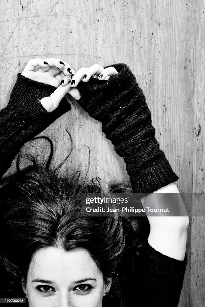 Young French woman laying on the floor and looking into the camera