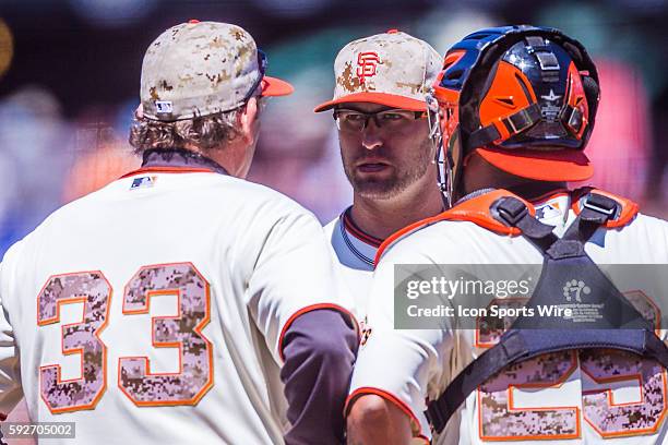 San Francisco Giants pitching coach Dave Righetti talks with San Francisco Giants relief pitcher David Huff and San Francisco Giants catcher Hector...