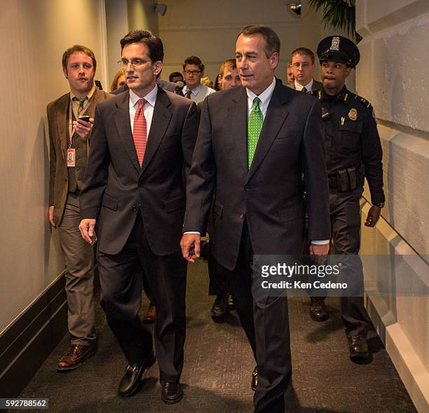 House Speaker John Boehner, right, and House Majority Leader from Eric Cantor left, walk into a Republican caucus meeting to consider the terms of...