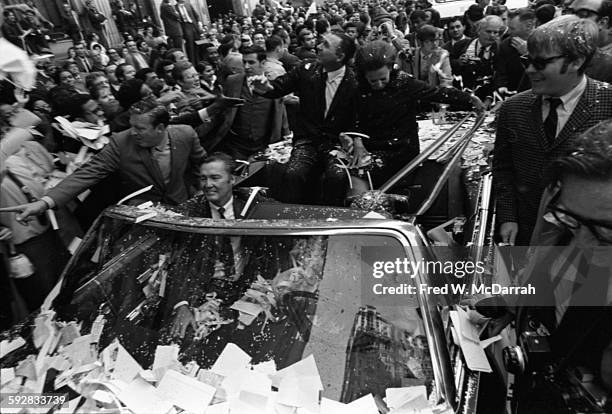 New York Mayor John Lindsay and New York Mets baseball manager Gil Hodges with his wife, Joan ride in an open-top convertible during a ticker tape...