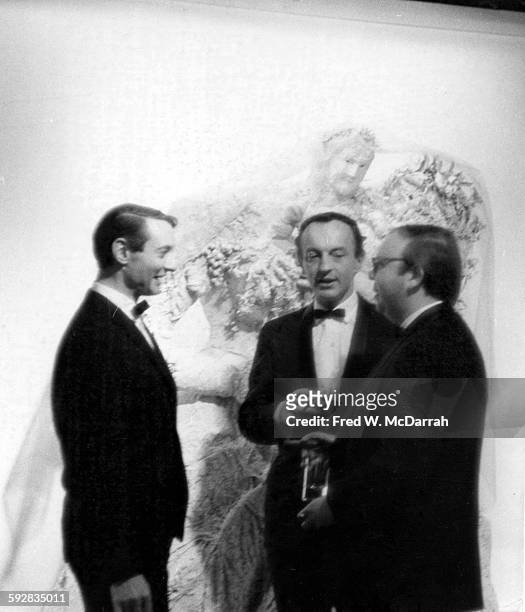 From left, American Pop artist Roy Lichtenstein , author and critic Frank O'Hara , and curator and critic Henry Geldzahler talk together as they...