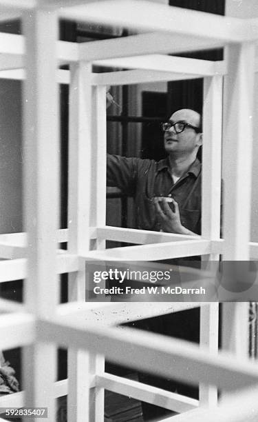 American artist Sol Lewitt paints one of his sculptures as he installs an exhibit at the Jewish Museum, New York, New York, April 26, 1966.