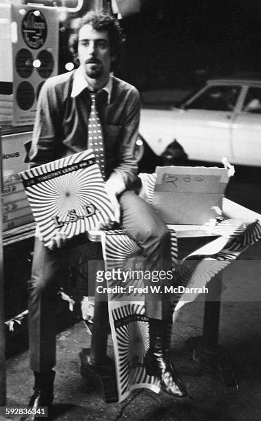On Second Avenue, a bearded young man in a necktie sells copies of Dr Timothy Leary's 'LSD' record from a sidewalk table, New York, New York,...