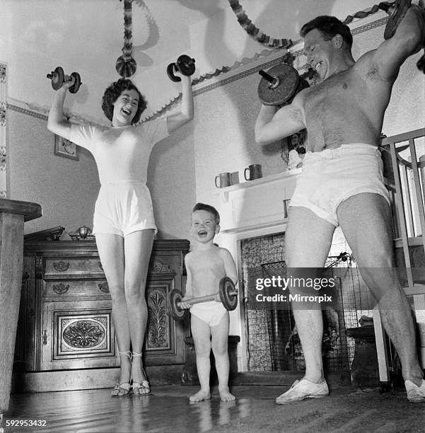 The Pickle family is a strong family as these picture show mum and dad weight training with son Eric. November 1953 D6683-001
