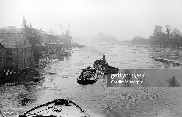 The river tug Thames makes it's way through the frozen river Thames at Teddington January 1940