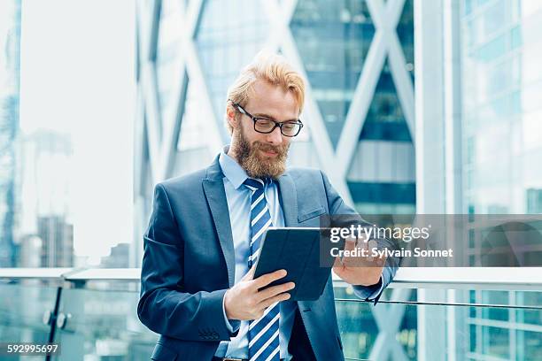 businessman using a digital tablet - holding railing stock pictures, royalty-free photos & images