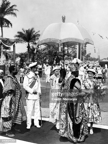 Queen Elizabeth II and Prince Philip bid farewell to the Oba Adenji-Adele II, at the dias at the Igbobi roundabout on the outskirts of Lagos during...
