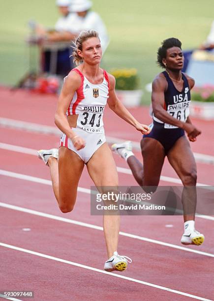 Katrin Krabbe of Germany and Carlette Guidry of the USA run the 100 meter event of the 1991 IAAF World Championships during August 1991 at the...
