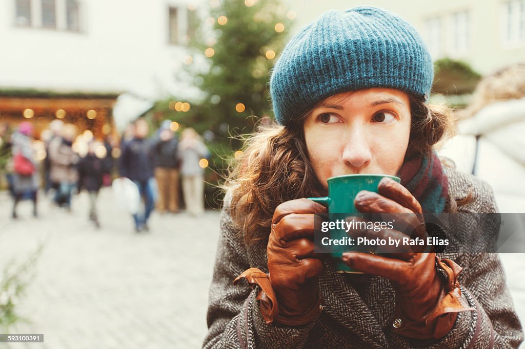 Woman drinking hot wine at the Christmas market