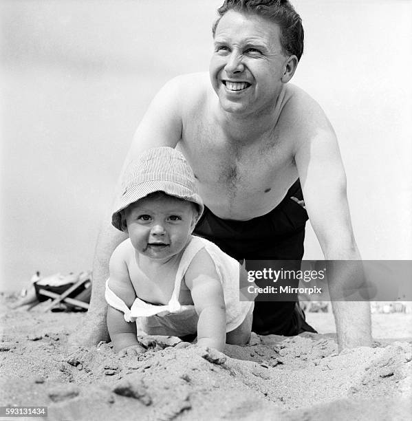 Nine month old Paul Kemshell crawling on the sands at Rhyl with his daddy Mr. Brian Kemshell of Rhyl. June 1960 M4315-005