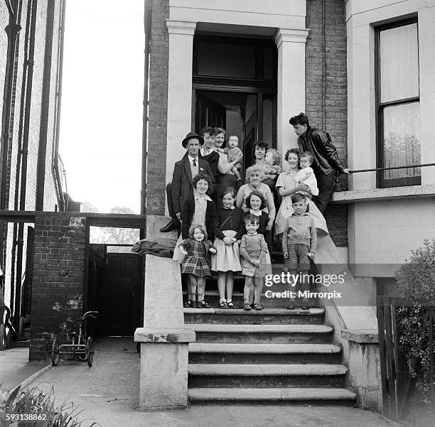 The O'Brien family standing on the front steps outside their flat in New Cross, London. September 1961.