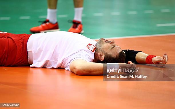 Bartosz Jurecki lies on the ground during the Men's Bronze Medal Match between Poland and Germany on Day 16 of the Rio 2016 Olympic Games at Future...