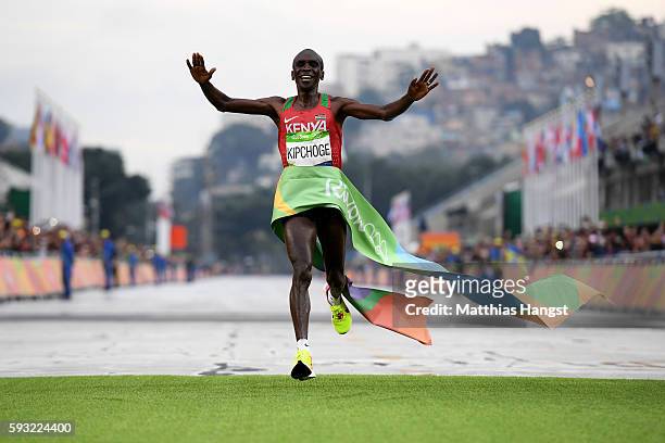 Eliud Kipchoge of Kenya celebrates as he crosses the line to win gold during the Men's Marathon on Day 16 of the Rio 2016 Olympic Games at Sambodromo...