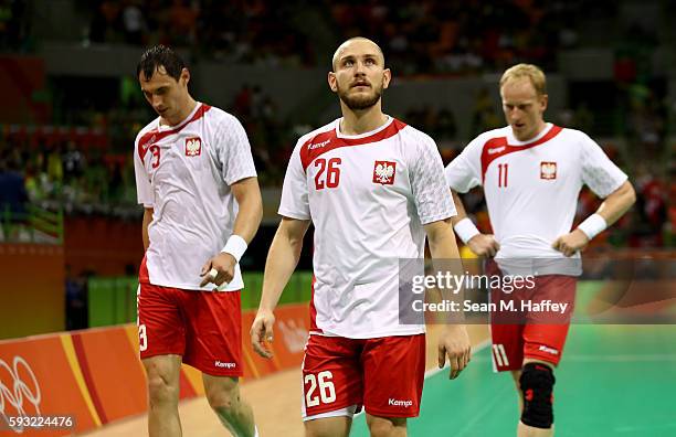 Krzysztof Lijewski, Michal Daszek and Adam Wisniewski of Poland look dejected during the Men's Bronze Medal Match between Poland and Germany on Day...