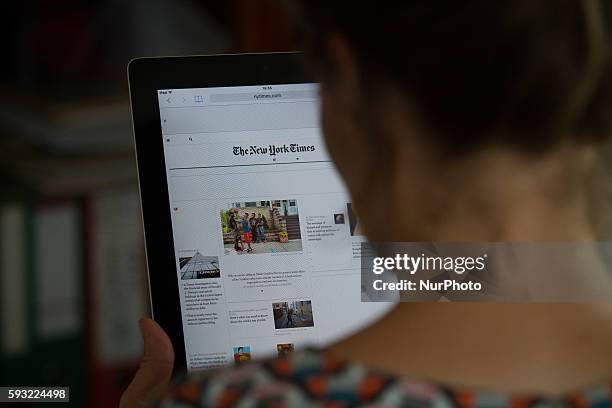 Person is seen reading the electronic version of the New York Times on a tablet in Bydgoszcz, Poland, on August 21 2016.