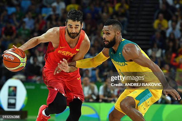 Spain's guard Juan-Carlos Navarro works around Australia's guard Patty Mills during a Men's Bronze medal basketball match between Australia and Spain...