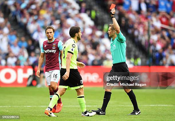 Referee Craig Pawson shows the red card to Harry Arter of AFC Bournemouth during the Premier League match between West Ham United and AFC Bournemouth...