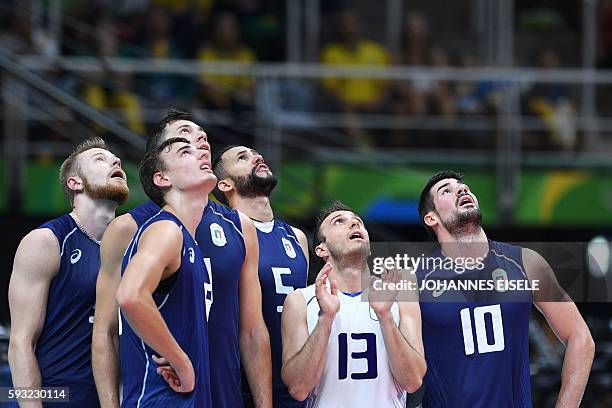 Italy's Ivan Zaytsev, Italy's Simone Giannelli, Italy's Osmany Juantorena, Italy's Massimo Colaci and Italy's Filippo Lanza look up at a screen to...