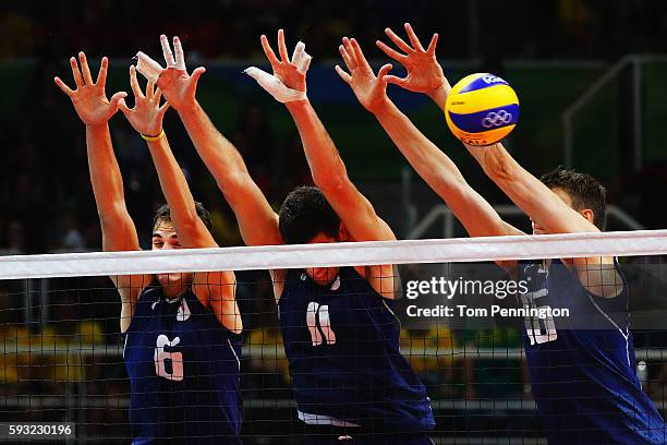 Simone Giannelli of Italy, Simone Buti of Italy and Oleg Antonov of Italy block during the Men's Gold Medal Match between Italy and Brazil on Day 16...