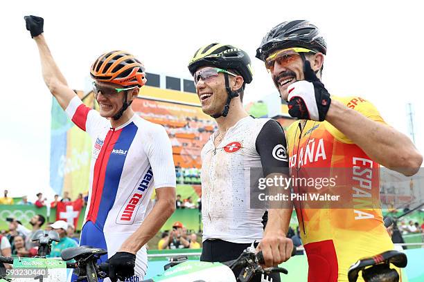 Jaroslav Kulhavy of Czech Republic, silver, Nino Schurter of Switzerland, gold, and Carlos Coloma Nicolas of Spain, bronze, celebrate after the Men's...