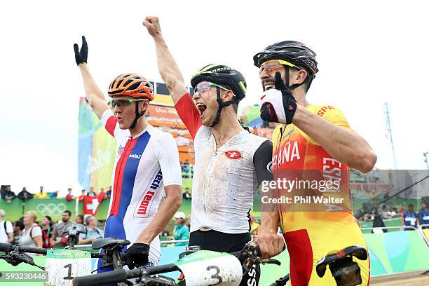 Jaroslav Kulhavy of Czech Republic, silver, Nino Schurter of Switzerland, gold, and Carlos Coloma Nicolas of Spain, bronze, celebrate after the Men's...