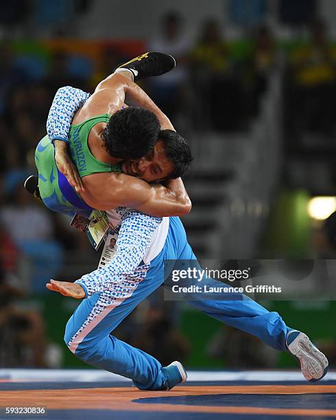 Ikhtiyor Navruzov of Uzbekistan and coach celebrate after winning the bronze in the Men's Freestyle 65kg Bronze match against Mandakhnaran Ganzorig...