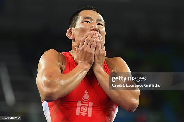 Mandakhnaran Ganzorig of Mongolia reacts following his defeat to Ikhtiyor Navruzov of Uzbekistan in the Men's Freestyle 65kg Bronze match against on...