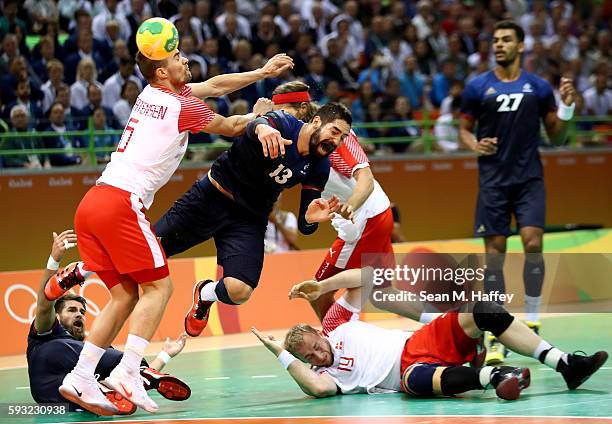 Nikola Karabatic of France loses the ball against Casper Mortensen of Denmark during the first half in the Men's Gold Medal Match between Denmark and...