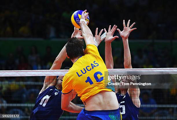 Lucas Saatkamp of Brazil spikes the ball during the Men's Gold Medal Match between Italy and Brazil on Day 16 of the Rio 2016 Olympic Games at...