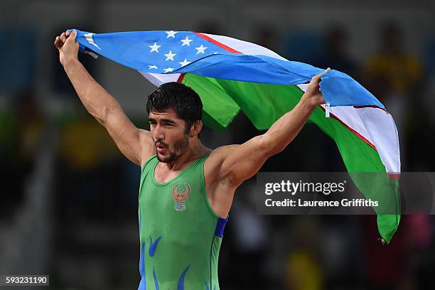 Ikhtiyor Navruzov of Uzbekistan celebrates after winning the bronze in the Men's Freestyle 65kg Bronze match against Mandakhnaran Ganzorig of...