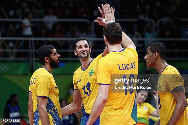 Mauricio Luiz de Souza and Lucas Saatkamp of Brazil celebrate during the Men's Gold Medal Match between Italy and Brazil on Day 16 of the Rio 2016...