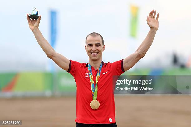 Gold medalist, Nino Schurter of Switzerland poses on the podium during the medal ceremony for Men's Cross-Country on Day 16 of the Rio 2016 Olympic...