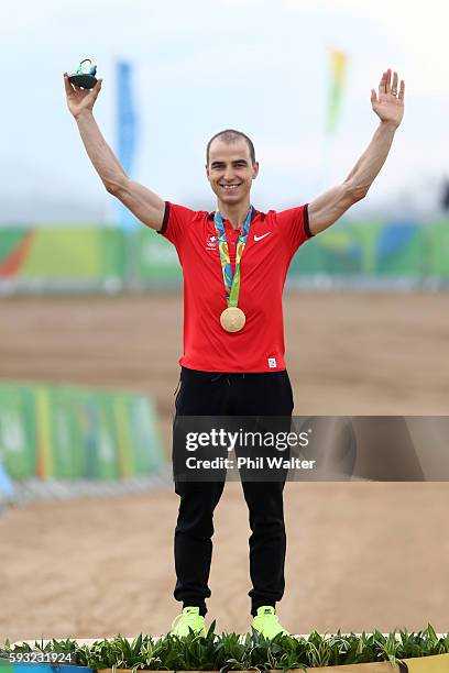 Gold medalist, Nino Schurter of Switzerland poses on the podium during the medal ceremony for Men's Cross-Country on Day 16 of the Rio 2016 Olympic...