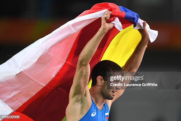 Soslan Ramonov of Russia celebrates after winning the gold in the Men's Freestyle 65kg Gold match against Toghrul Asgarov of Azerbaijan on Day 16 of...