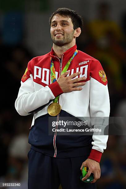 Gold medalist Soslan Ramonov of Russia stands on the podium during the medal ceremony for the Men's Freestyle 65kg event on Day 16 of the Rio 2016...